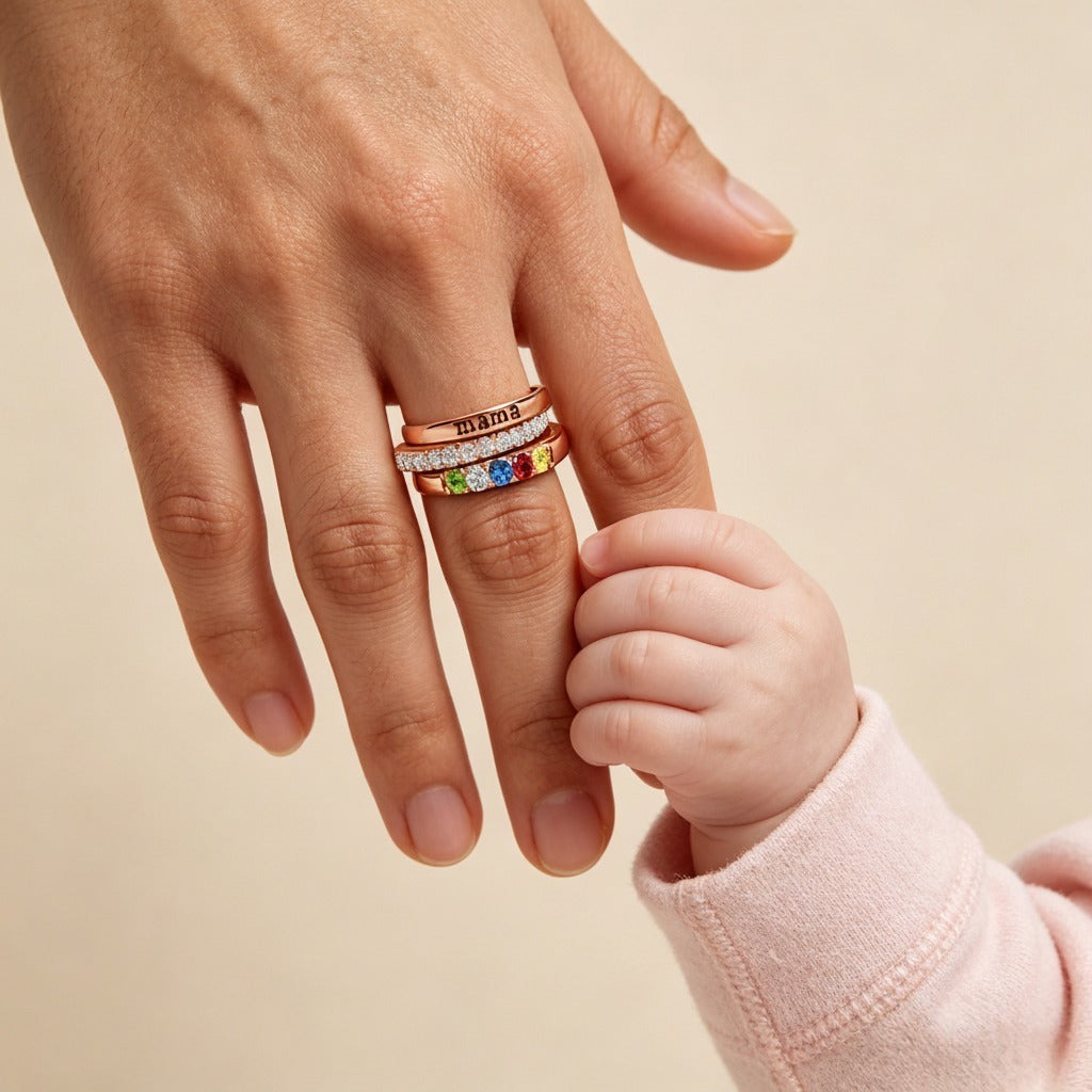 Mama birthstone ring set worn while holding a child's hand