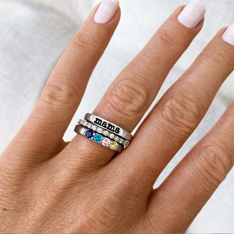 Silver-tone Mama birthstone ring set worn on a hand